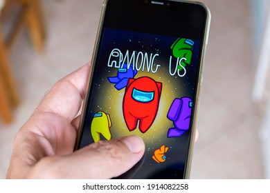 São Paulo, Brazil - February 10, 2021: cell phone in the hand of game Among US, which was the most downloaded game of the cell phone in 2020.