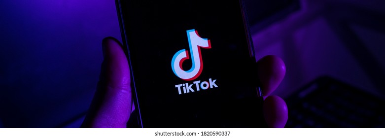 São Paulo, SP, Brazil September 20 2020: Man Holding Cell Phone With TikTok IPhone App X Close-up Of The Screen.