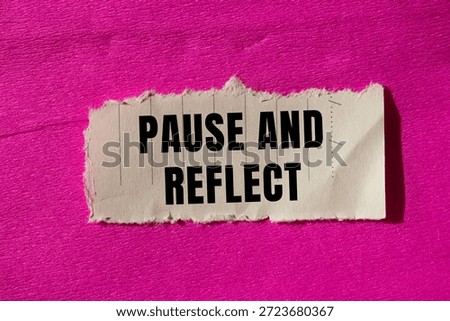 Pause and reflect message written on ripped torn paper background. Conceptual Pause and reflect symbol. Copy space.