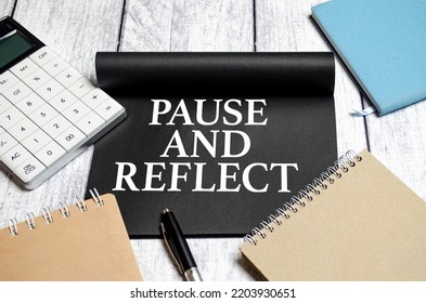 Pause And Reflect The Phrase On Black Paper And Pen