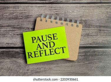 Pause And Reflect The Phrase On Green Paper And Pen