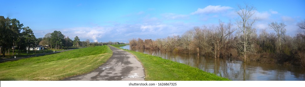 Paved bike path on top of earthen dike levee along Mississippi River in Louisiana  - Shutterstock ID 1626867325