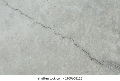 Paved floor outside the building with a long crack.