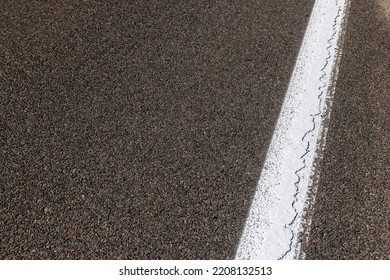 Paved highway with white road markings, traffic regulation using lines on asphalt
