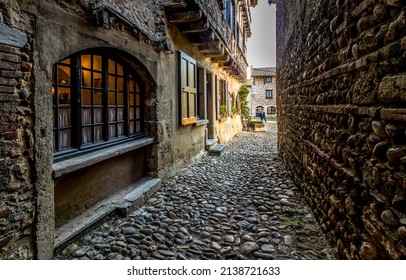 A paved narrow street in the old city of Europe. Medieval pavement narrow street. Paved narrow street