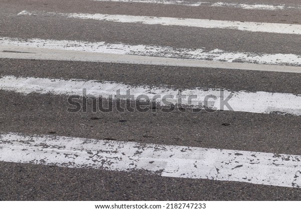 paved road for car\
traffic, road for vehicles with white road markings on the asphalt,\
pedestrian crossing