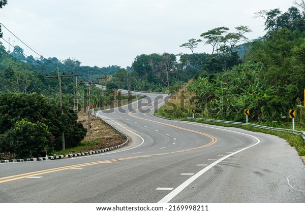 Paved road curve on\
mountains.Road dividing line.The road to the mountain.The asphalt\
road on both