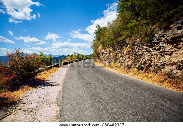 Paved road in the\
mountains far away