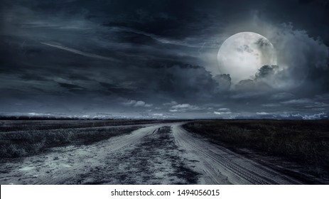 Paved Road Through A Field Of Wheat At Night. Storm