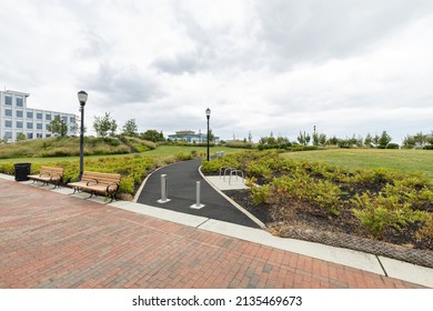 A paved walking path leads into RCA Pier Park, an urban revitalization project on the Delaware River waterfront in Camden, New Jersey, USA - Powered by Shutterstock