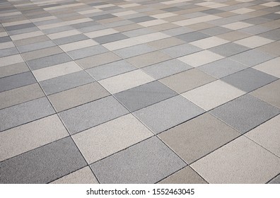 pavement in the city, made of washed concrete slabs in shades of gray