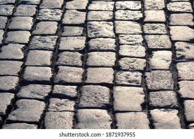 pavement close up in the sunlight. background texture of street stone