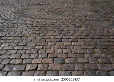 Pavement road. Stone cladding. Rough brick road. Cobblestone pavement background. Textured background. Sidewalk. Road. Old cobblestone road.