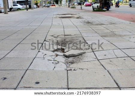 The pavement surface is damaged.  Broken brick blocks can pose a danger to pedestrians.