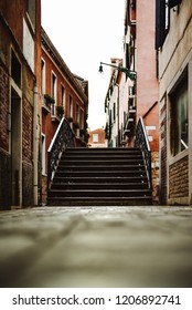 Pavement View Of A Small Steel Bridge In Venice