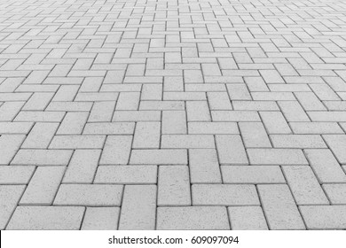 Paver brick floor also call brick paving, paving stone or block paving.
Manufactured from concrete or stone for road, path, driveway and patio. Empty floor in perspective view for texture background.