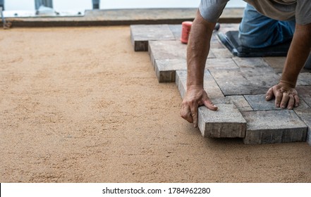 Pavers Being Installed By Hand 