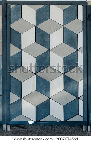 Pavers creating a repeating geometric pattern with a striking 3d cube optical illusion