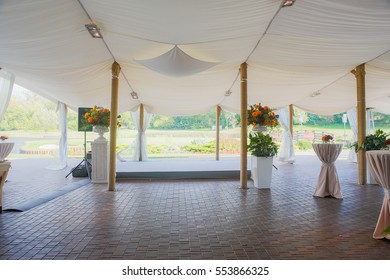 Pavilion made of white cloth and decorated with flower bouquets - Powered by Shutterstock