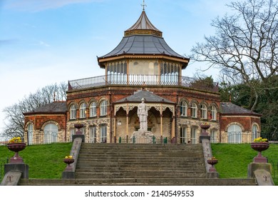 The Pavilion, Menses Park, Wigan, England.  19th century Victorian pavilion in a public park with blue sky behind.