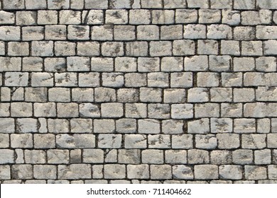 Paving blocks made of small tiles of regular shape, seamless texture