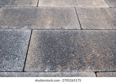 paving slabs made of rectangular blocks of yellow and gray colors.
