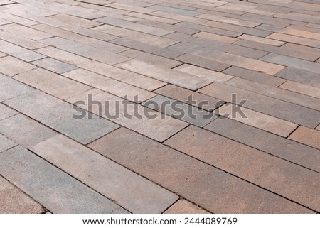 Paving slabs of rectangular elongated shape of different sizes and colors. Angled view.