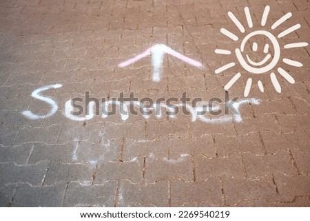 paving slabs, walking, cycling path, pedestrian path with text summer and arrow, sun, drawn with white chalk, change seasons, arrival warm season, expectation of vacation, travel, summer holidays