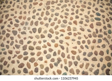 ?obblestone as paving stone, Conglomerate of assorted irregular pebbles in cement