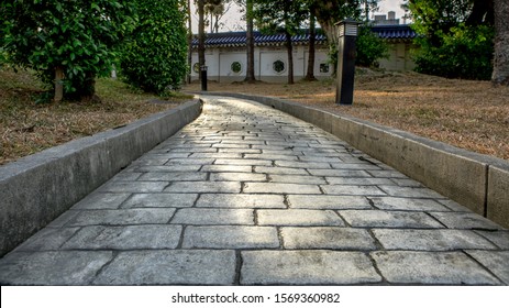 Paving Stone Road. Old Pavement Of Square Cobblestone Sidewalk In Taipei. Garden Patio In Backyard Stone Brick Pavers In Taiwan. Concrete Paver Block Floor For Background.