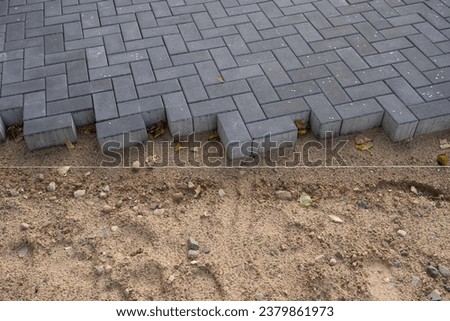 paving work on a construction site for a new sidewalk 