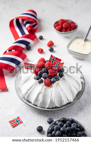 Pavlova cake with strawberries and blueberries and vanilla cream. Norwegian constitutional day. 17th May. 