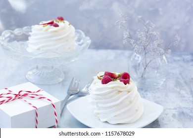 Pavlova cakes with cream and fresh summer berries