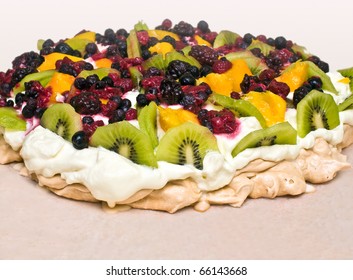 Pavlova dessert with kiwi, mango and berries