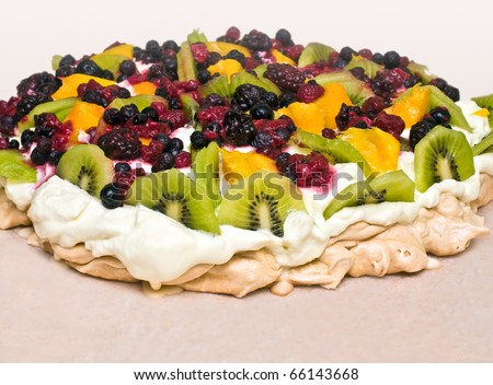 Pavlova dessert with kiwi, mango and berries