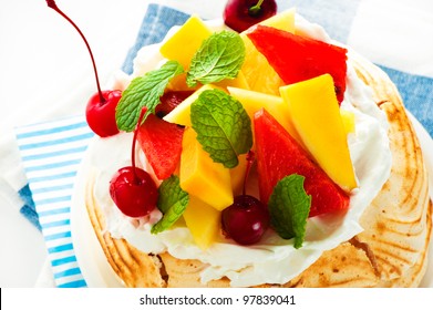 Pavlova With Fresh Fruit (mango, Pineapple, Watermelon, Cherry) Ready  To Serve, On White Background As A Studio Shot