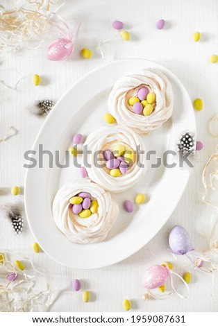 Pavlova mini cakes with Easter motif decoration, top down view