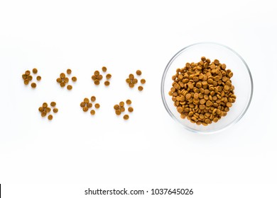 Paw Sign Made Of Dry Cat Or Dog Food With Full Bowl. Pet Care And Veterinary Concept With Letters On White Background.