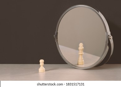 Pawn sees himself as a king looking in the mirror. Self-regard or vanity concept. - Shutterstock ID 1831517131
