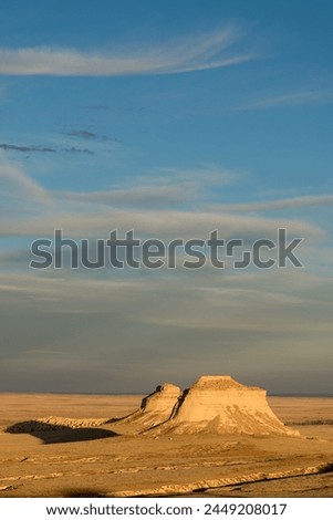 The Pawnee Buttes which rise 300 feet above the Pawnee prairie grassland are eroded geologic landmarks in northeastern Colorado. This is a dramatic late afternoon early fall sunset on both Buttes.