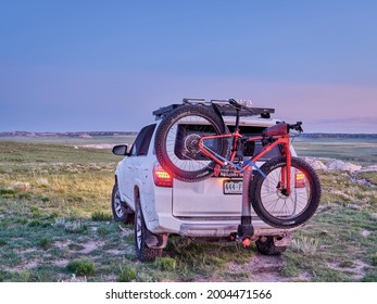 Pawnee National Grassland, CO, USA - June 2, 2021: Toyota 4Runner SUV With Salsa Mukluk Fat Bike On Yakima Hitch Rack At Dawn In A Prairie In Northern Colorado.