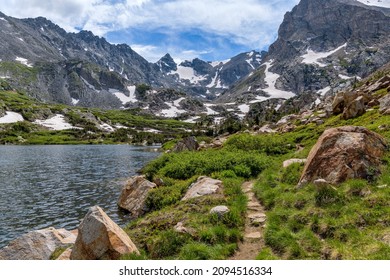 Pawnee Pass Trail - A Spring day view of Pawnee Pass Trail winding at west end of Lake Isabelle towards rugged Indian Peaks.  Indian Peaks Wilderness, Colorado, USA. - Shutterstock ID 2094516334