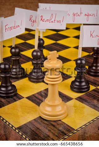 Pawns demonstrating against the king, a social unrest concept on a chess board