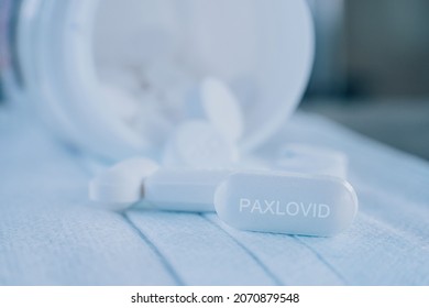 Paxlovid Tablet Medication For Treatment Covid19, Potential New Drug Cure For COVID 19 Corona Virus Closeup. Therapy For Koronavirus. Pharmaceuticals On Mask.