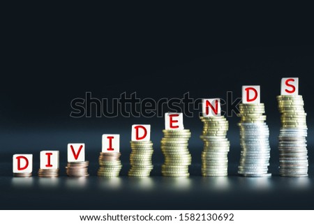 Pay dividends concept suggesting evolution of stock yield on the market with coins money ladder
