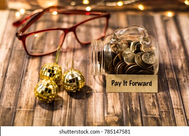 Pay It Forward Money Jar Savings Motivational Concept On Wooden Board 