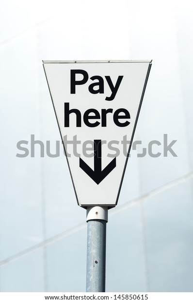 Pay Here sign. Pay\
and display carpark. 