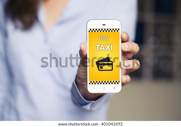 Pay Taxi message on a mobile\
phone screen. Woman holding a smartphone with taxi payment\
software.
