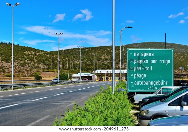 Pay Toll sign in different languages on the\
road between Tetovo and Skopje. The toll for road use is collected\
by an open toll collection system at 10 toll plazas. Zhelino, North\
Macedonia -09-18-2021