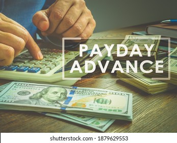 Payday Advance Loan Concept. Calculator And Wads Of Money.